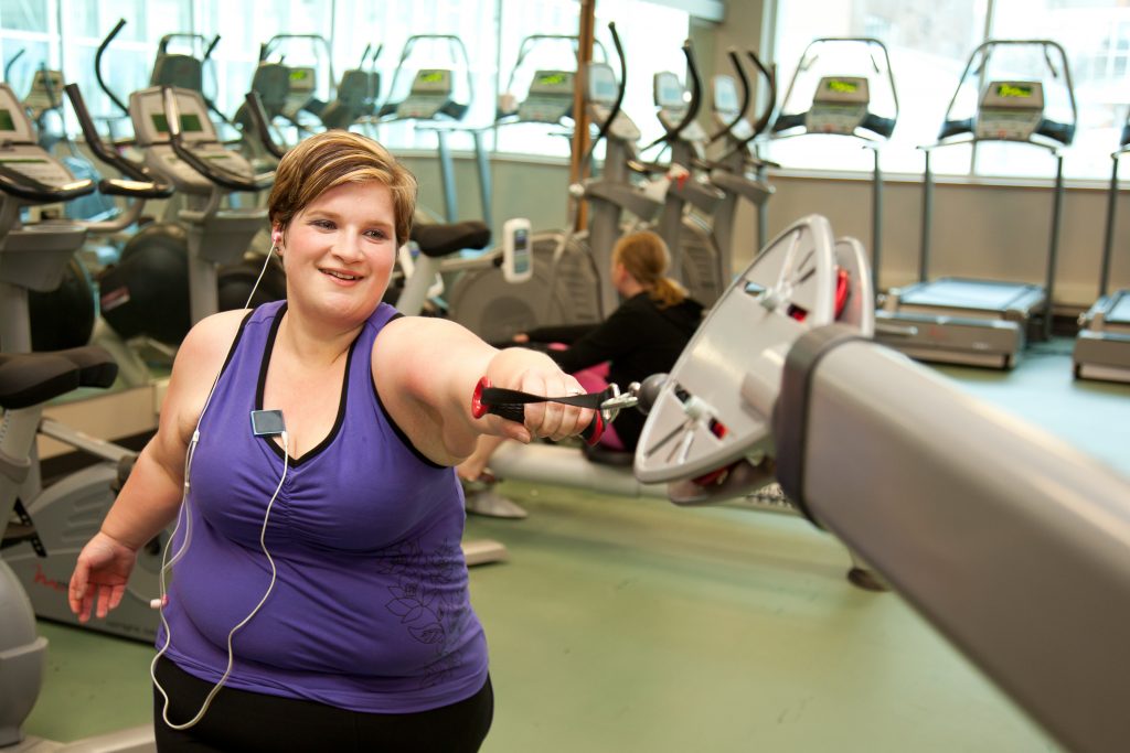 Woman in gym using exercise machine