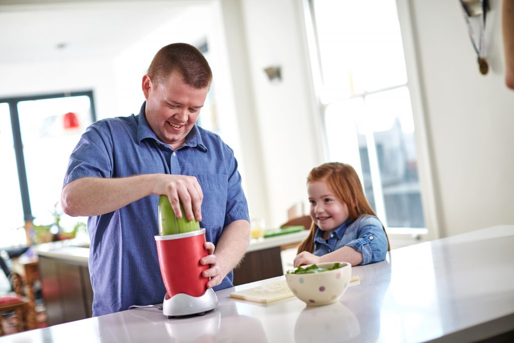 Dad and daughter making smoothies