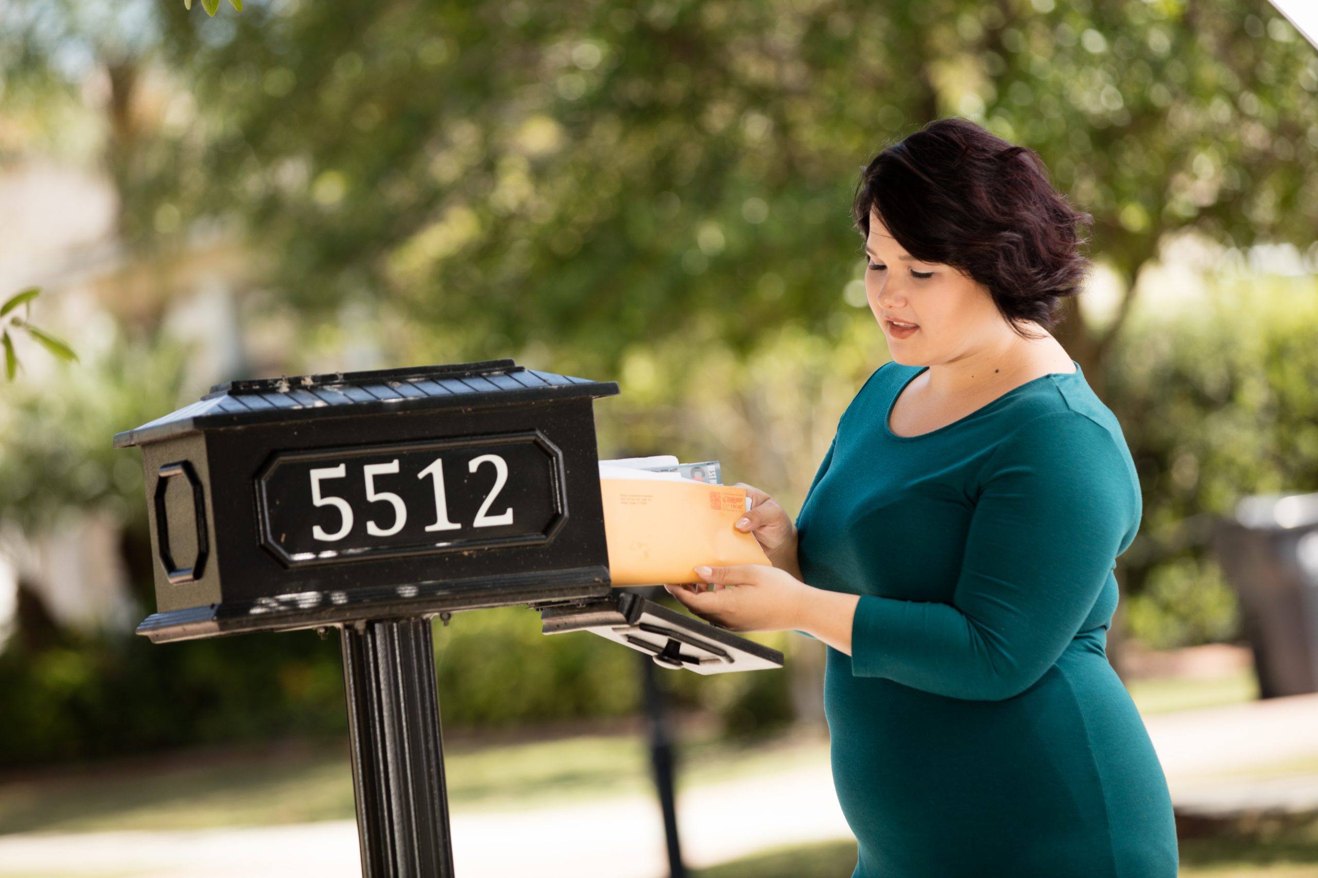 Young women taking mail out of her mail box