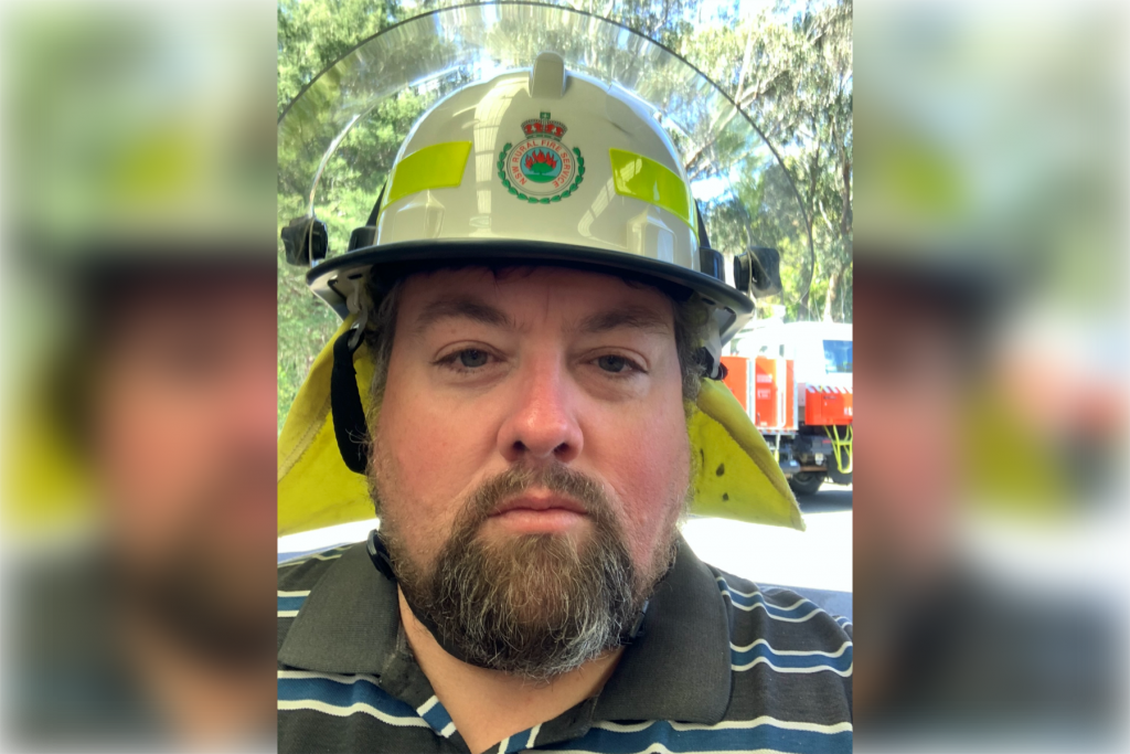 Middle aged man in fire fighters helmet