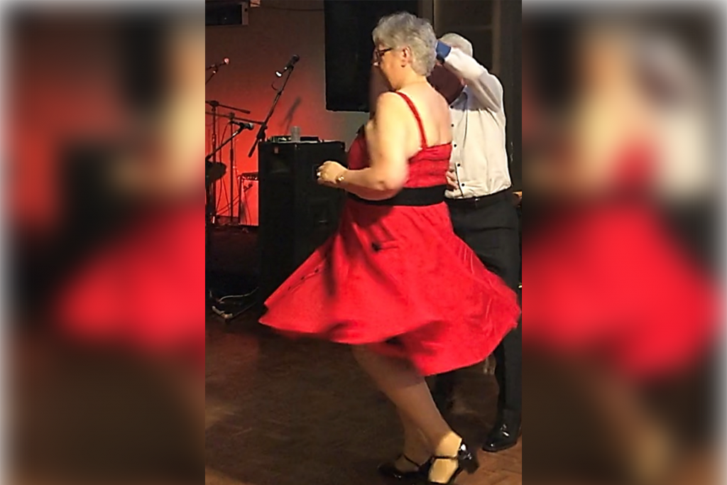 Older woman dancing in red dress